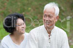 Mature Asian couple outdoor portrait.
