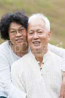 Old Asian couple relaxing outdoor.