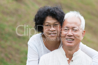 Elderly Asian couple relaxing outdoor.