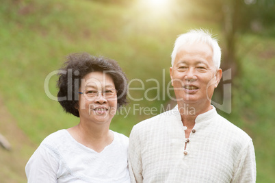 Senior Asian couple smiling outdoor.