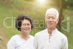 Senior Asian couple smiling outdoor.