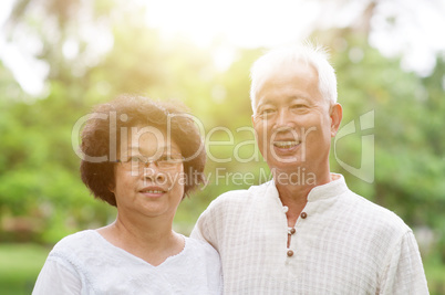 Happy elderly Asian couple smiling.