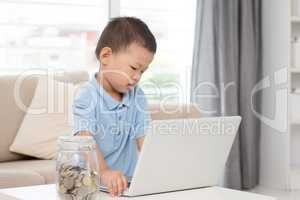 Asian boy and computer laptop.