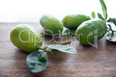 Fresg organic green lemons with leaves