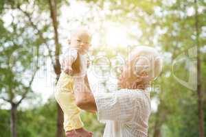 Grandparent and grandchild outdoors.