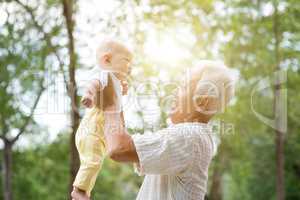 Grandparent holding grandchild.