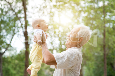 Grandparent carrying grandchild.