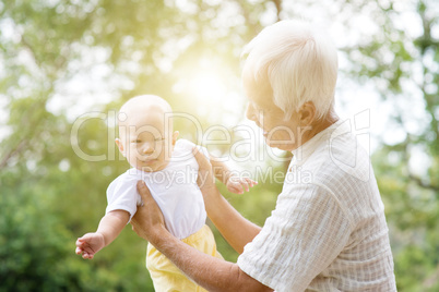 Grandparent taking care grandchild.