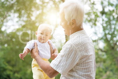 Grandparent and grandchild at outdoor park.