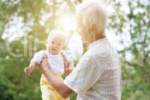 Grandparent and grandchild at outdoor park.