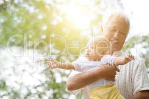 Grandfather playing with grandson.