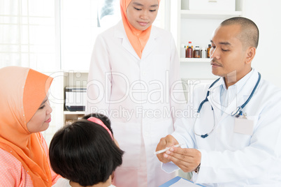 Doctor checking temperature of sick patient