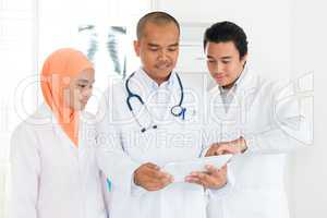 Medical team discussing on tablet pc