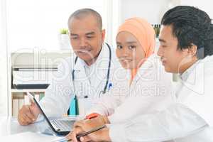 Medical team discussing at hospital office.