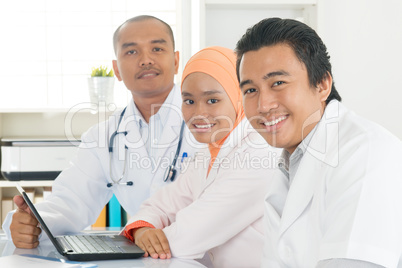 Medical team working together at hospital office.