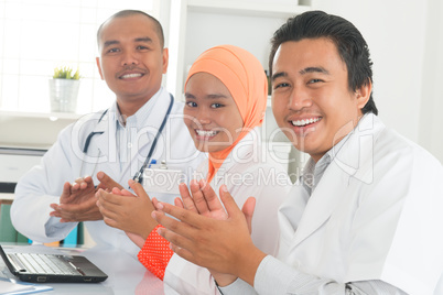 Medical doctors clapping hands