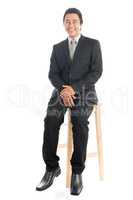 Full body Asian businessman sitting on chair