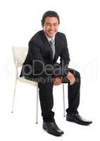Seated Southeast Asian businessman