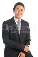 Asian businessman seated on chair