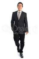 Full body Asian businessman walking