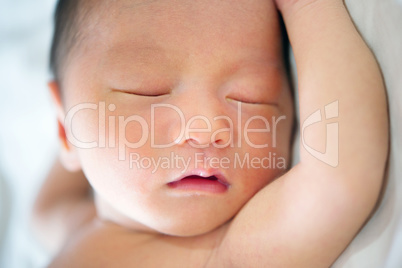 New born baby boy sleeping close up