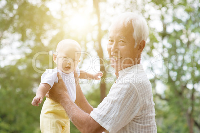 Grandparent and grandchild at park.