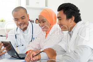 Asian medical doctors discussing at hospital office.