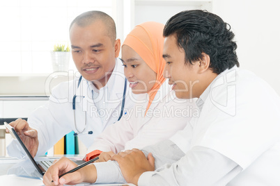 Asian doctors discussing at hospital office.