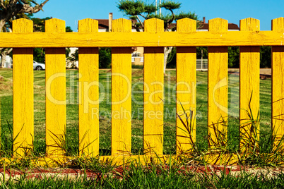 Yellow wooden fence.