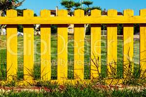 Yellow wooden fence.