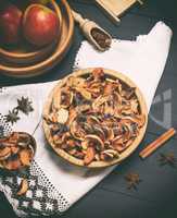 dried apple slices in a brown wooden bowl