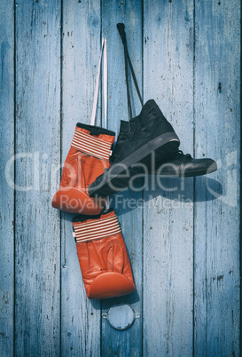 Black textile worn sneakers and red leather boxing gloves