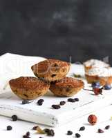 baked cupcakes with raisins on a white wooden board
