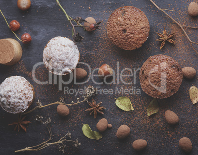 baked muffins on a black table, top view