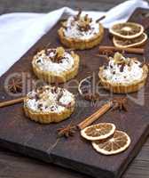 sweet cakes with white cream and chocolate powder