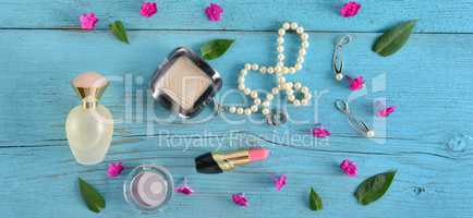 Cosmetics, perfumes and jewelry made of pearls on an old wooden