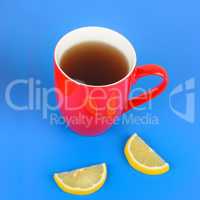 Red cup with tea on blue background. Flat lay,top view. Free