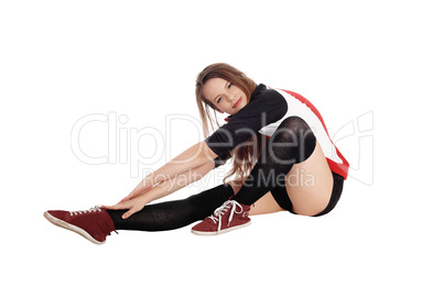 Young woman stretching on the floor