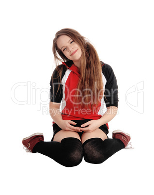 Young woman sitting  on the floor, smiling