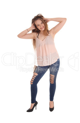 Young woman standing with her hands in her hair