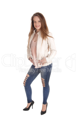 Young woman standing in jeans and jacket