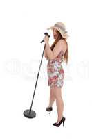 Woman standing and singing with straw hat