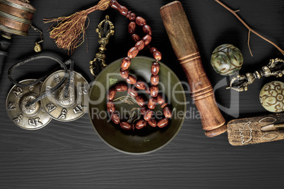 Copper singing bowl, prayer beads, prayer drum