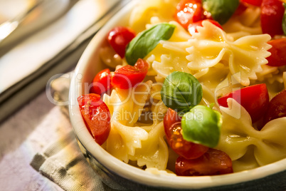 Closeup of Italian Farfalle pasta with tomatoes and basil