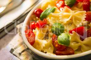 Closeup of Italian Farfalle pasta with tomatoes and basil