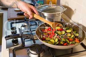 Whole farfalle pasta with zucchini, cherry tomatoes and red onio