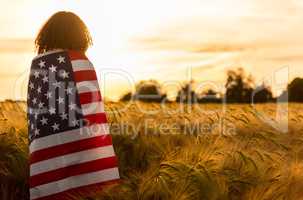 Woman Girl Teenager Wrapped in USA Flag in Field at Sunset