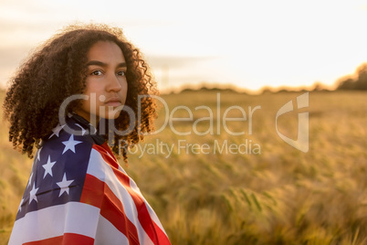 Sad Depressed Girl Woman Teenager Wrapped in USA Flag at Sunset