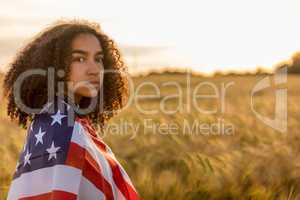 Sad Depressed Girl Woman Teenager Wrapped in USA Flag at Sunset