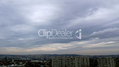 Timelapse of clouds over city rooftops